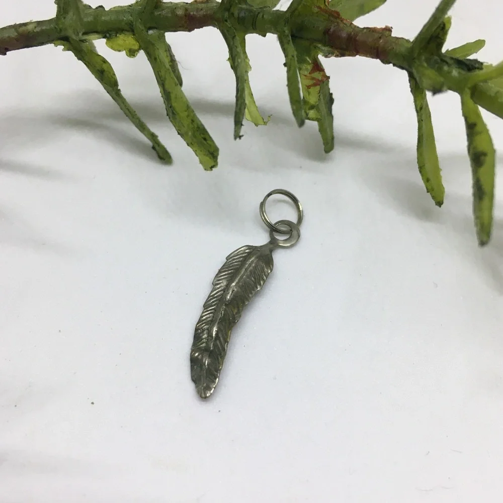 Feather shaped silver tone pendant charm